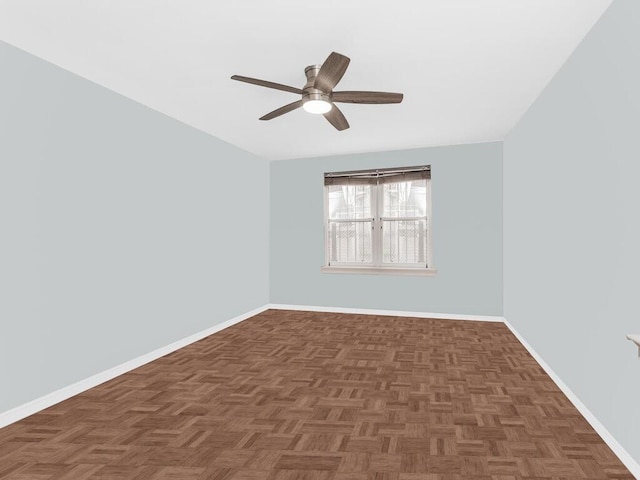 unfurnished room with dark parquet floors and ceiling fan