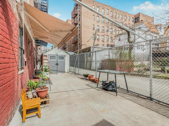 view of patio / terrace featuring a storage shed