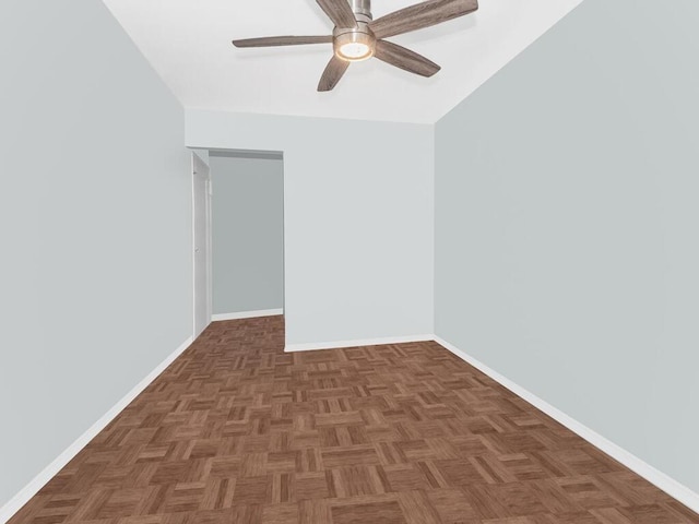 spare room featuring dark parquet floors and ceiling fan