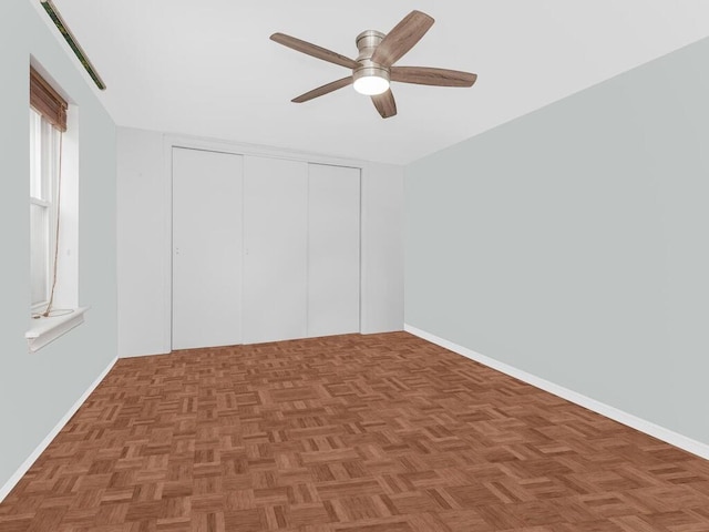 unfurnished bedroom with ceiling fan and parquet floors