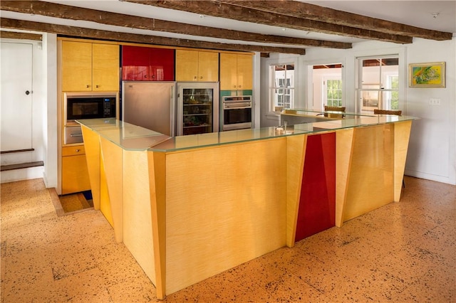 kitchen featuring built in appliances and beam ceiling