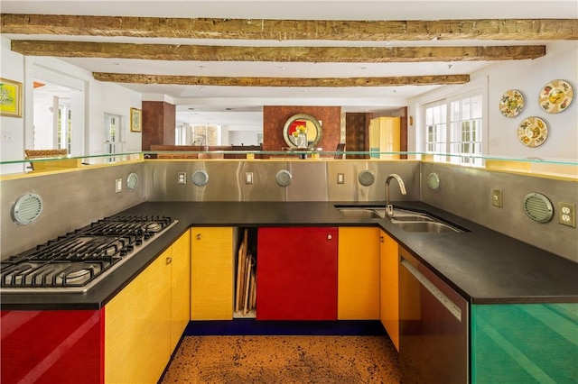 kitchen with beam ceiling, sink, and appliances with stainless steel finishes