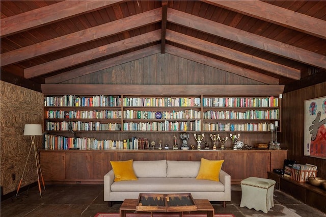 sitting room featuring vaulted ceiling with beams, dark tile patterned floors, and wood ceiling