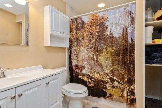 bathroom featuring curtained shower, vanity, and toilet