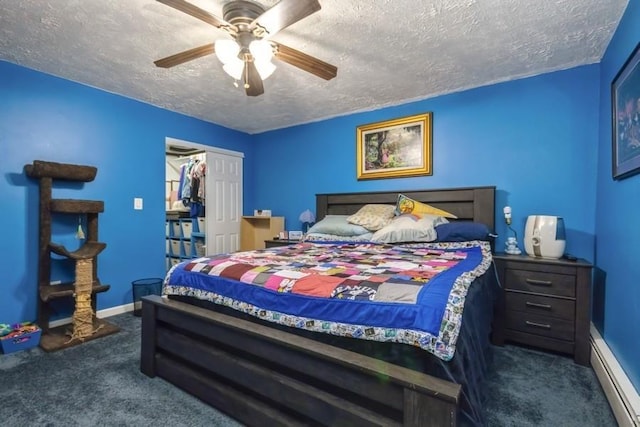 carpeted bedroom featuring ceiling fan, baseboards, baseboard heating, and a textured ceiling