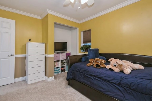 carpeted bedroom with ornamental molding, a ceiling fan, and baseboards