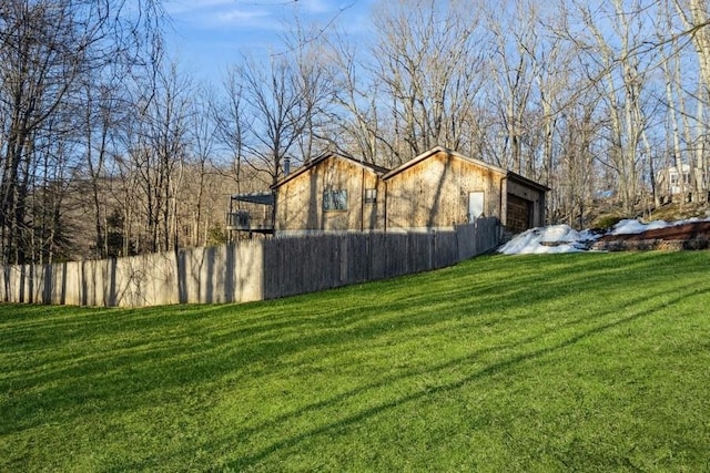 view of yard featuring fence and an attached garage