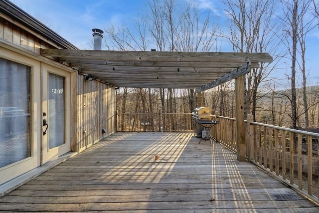 deck with grilling area and a pergola