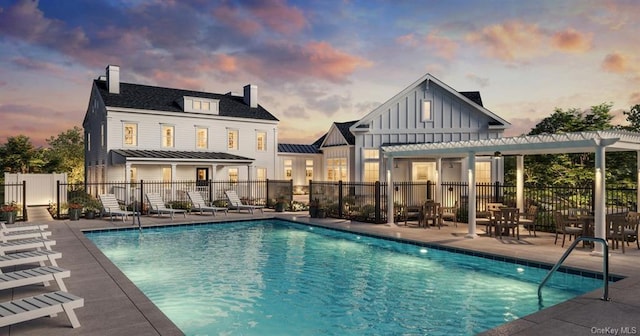 pool at dusk with a pergola and a patio