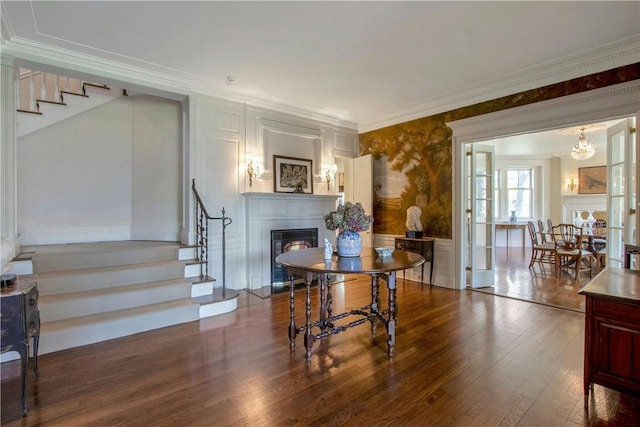 interior space featuring a chandelier, hardwood / wood-style flooring, and ornamental molding