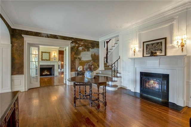 interior space with hardwood / wood-style floors and crown molding