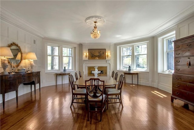 dining area with plenty of natural light, dark hardwood / wood-style flooring, and crown molding