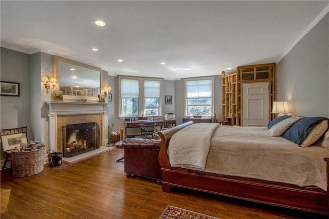 bedroom with hardwood / wood-style floors and ornamental molding