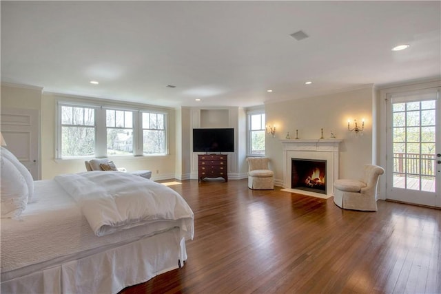 bedroom with access to exterior, hardwood / wood-style flooring, and crown molding