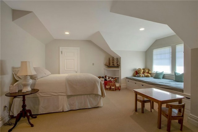 bedroom featuring lofted ceiling and light carpet