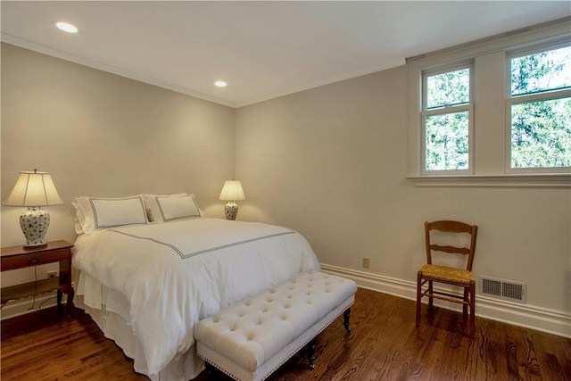 bedroom with dark hardwood / wood-style flooring and ornamental molding