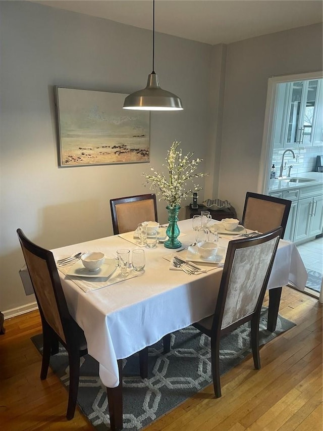 dining room featuring sink and light hardwood / wood-style flooring