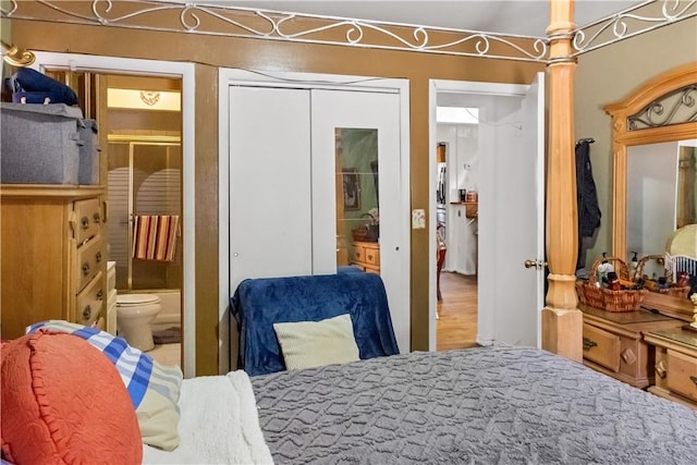 bedroom featuring hardwood / wood-style floors, connected bathroom, and a closet