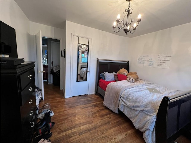 bedroom with dark hardwood / wood-style flooring and a chandelier