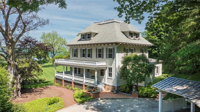 rear view of house with covered porch