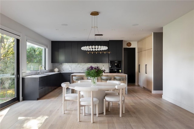 dining area featuring light hardwood / wood-style floors and sink