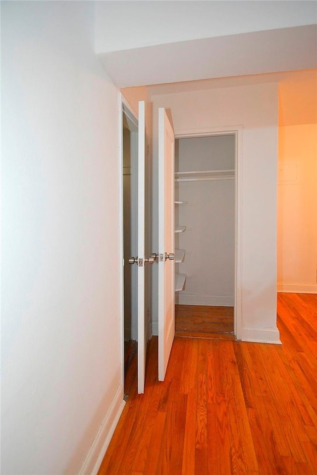 corridor featuring hardwood / wood-style floors