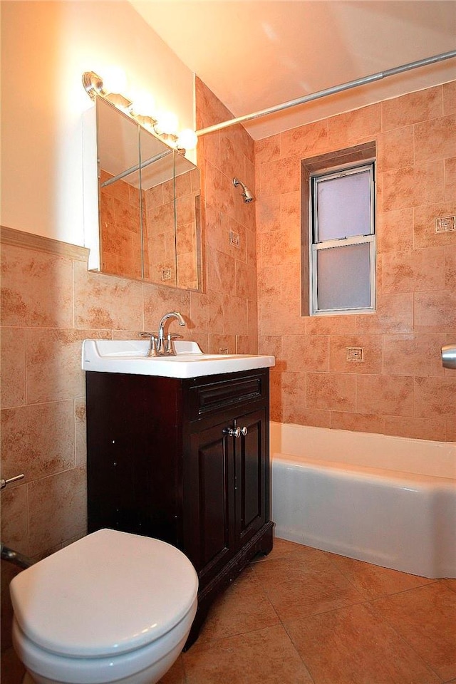 full bathroom with tile patterned floors, vanity, toilet, and tile walls