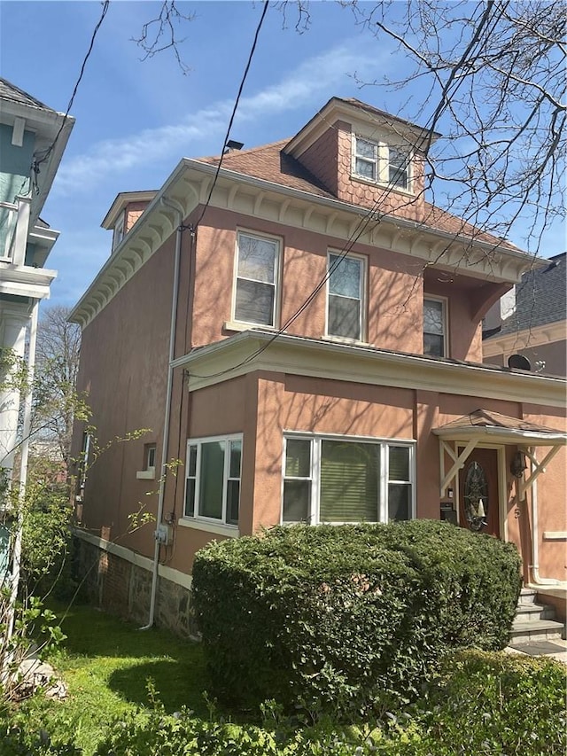 view of side of property with a lawn