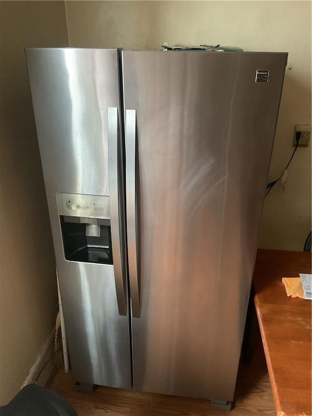 kitchen with stainless steel refrigerator with ice dispenser and light wood-type flooring