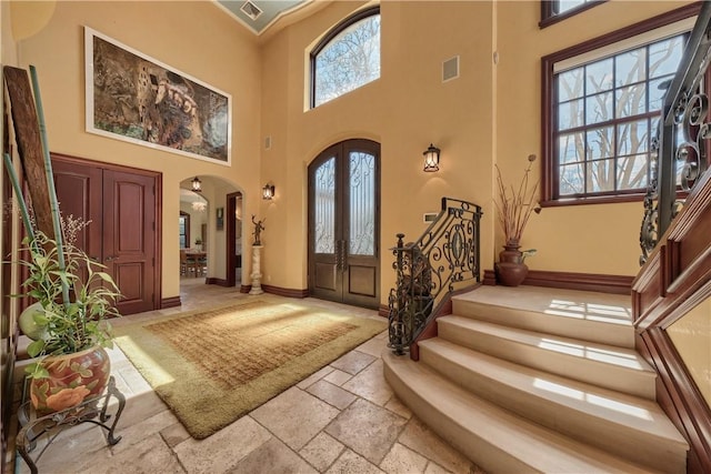 entrance foyer with french doors and a towering ceiling