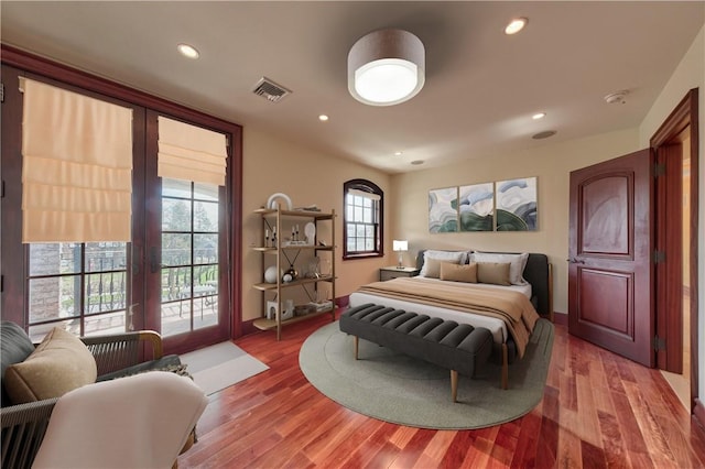 bedroom featuring access to outside and hardwood / wood-style flooring