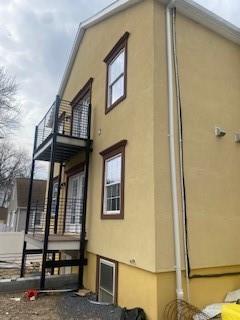 view of side of property with a balcony