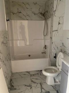 full bathroom with vanity, bathtub / shower combination, and toilet