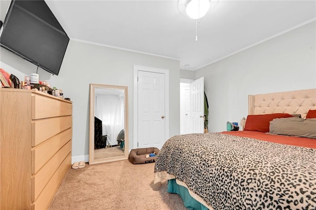 carpeted bedroom with a closet and ornamental molding