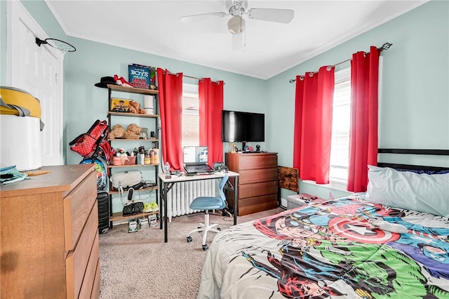 bedroom with ceiling fan, radiator heating unit, and light carpet