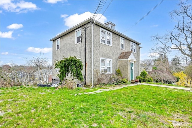 view of side of home featuring a yard