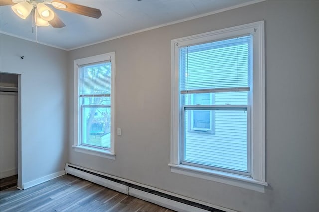 unfurnished bedroom featuring multiple windows, ceiling fan, hardwood / wood-style floors, and crown molding