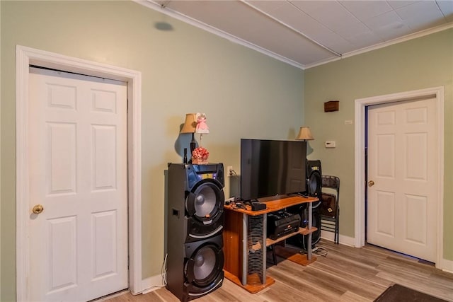 interior space with crown molding and light hardwood / wood-style flooring