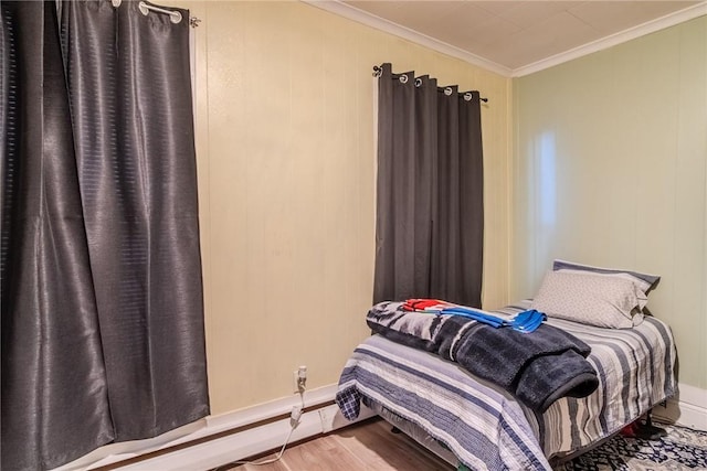 bedroom featuring crown molding and hardwood / wood-style flooring