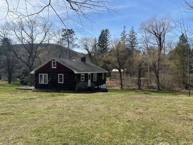 view of home's exterior with a lawn