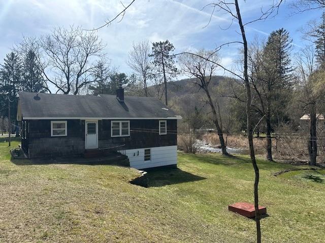 rear view of property featuring a yard