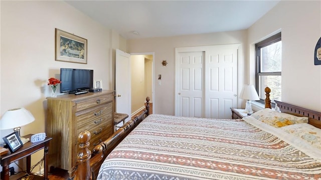 bedroom featuring dark hardwood / wood-style flooring and a closet