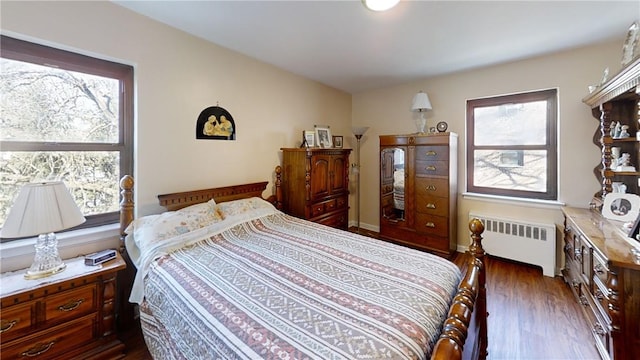 bedroom featuring dark wood-type flooring and radiator