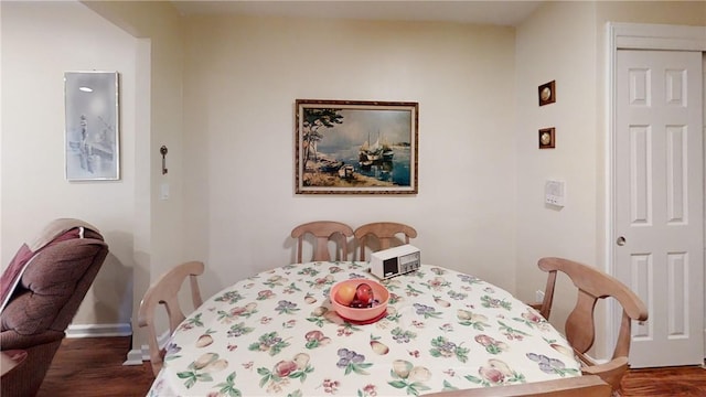 dining area with dark wood-type flooring