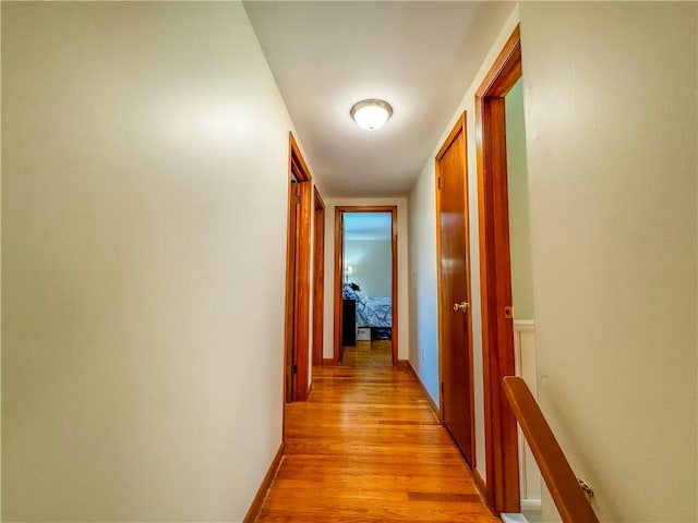 corridor with light hardwood / wood-style flooring