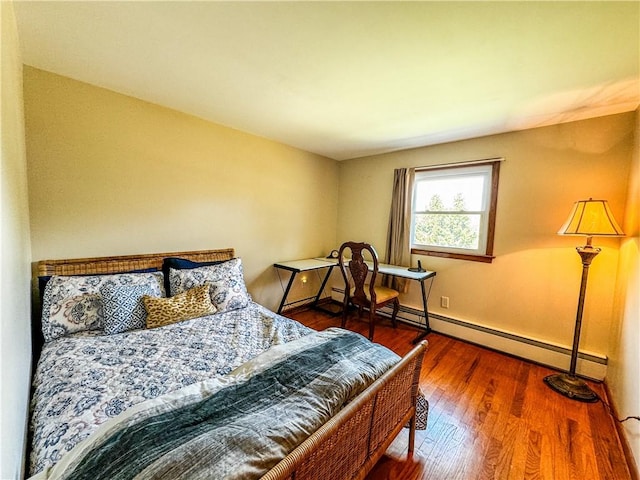 bedroom featuring dark wood-type flooring and a baseboard radiator