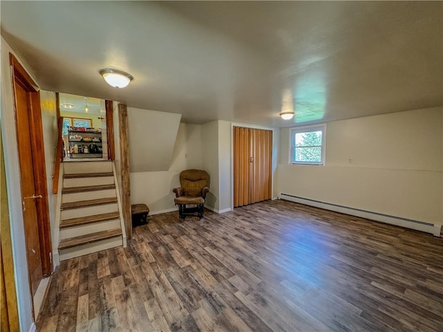 basement featuring hardwood / wood-style floors and baseboard heating