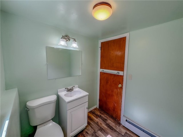 bathroom featuring vanity, toilet, wood-type flooring, and baseboard heating