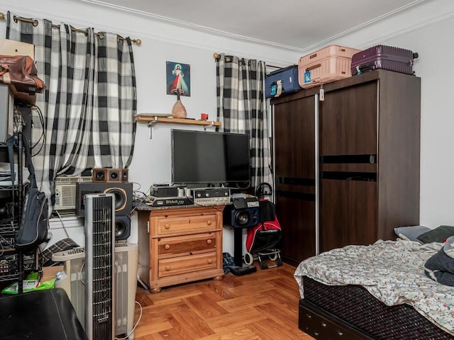 bedroom with light parquet floors and ornamental molding