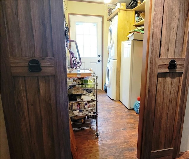 clothes washing area with stacked washer and dryer and dark wood-type flooring